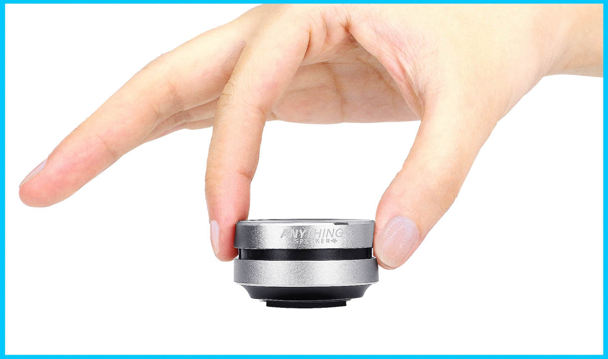 Close-up of hand holding Anything Speaker between two fingers