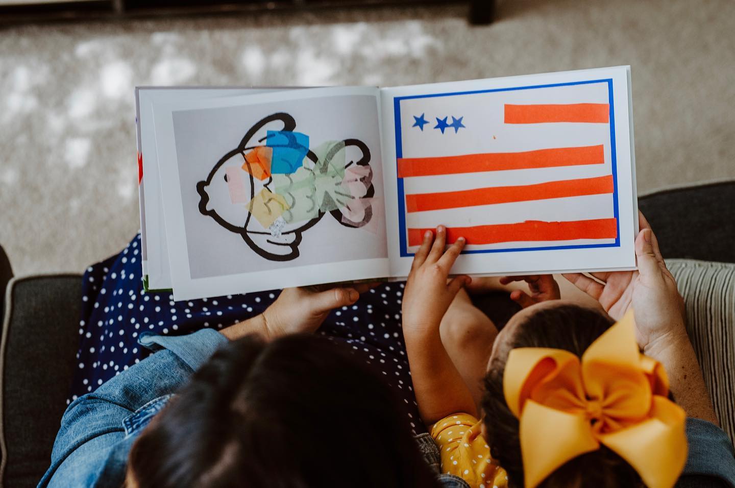 Adult and child looking at an open Artkive book together