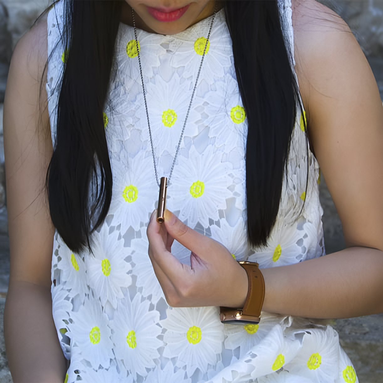 Person in a white floral dress holding and wearing the Moksha Beam