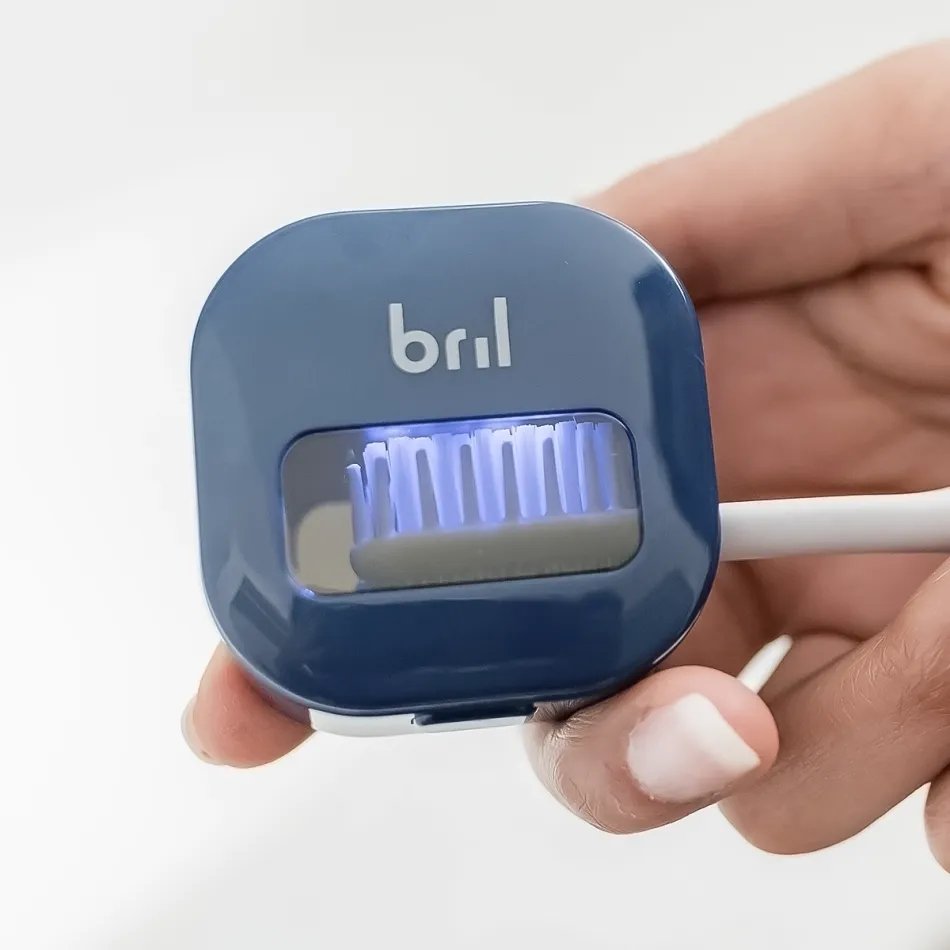 Toothbrush being placed into the Bril UV-C case