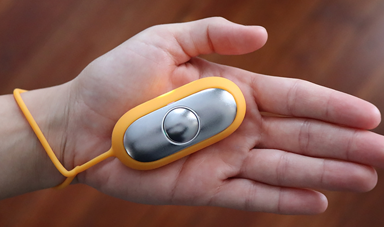 Close-up of a hand holding the Chill Pill device