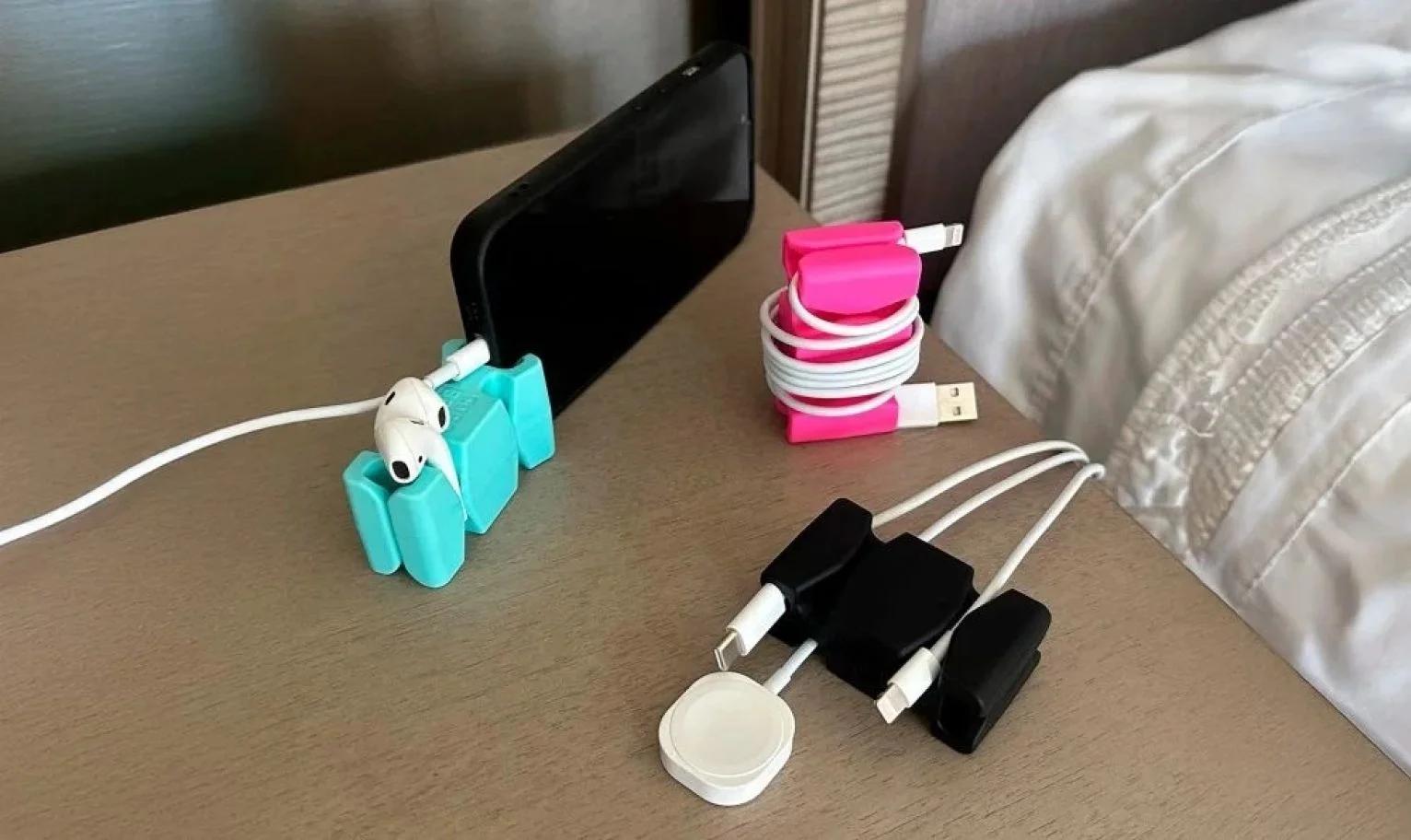 CordBrick devices in use on a bedside table, organizing cables