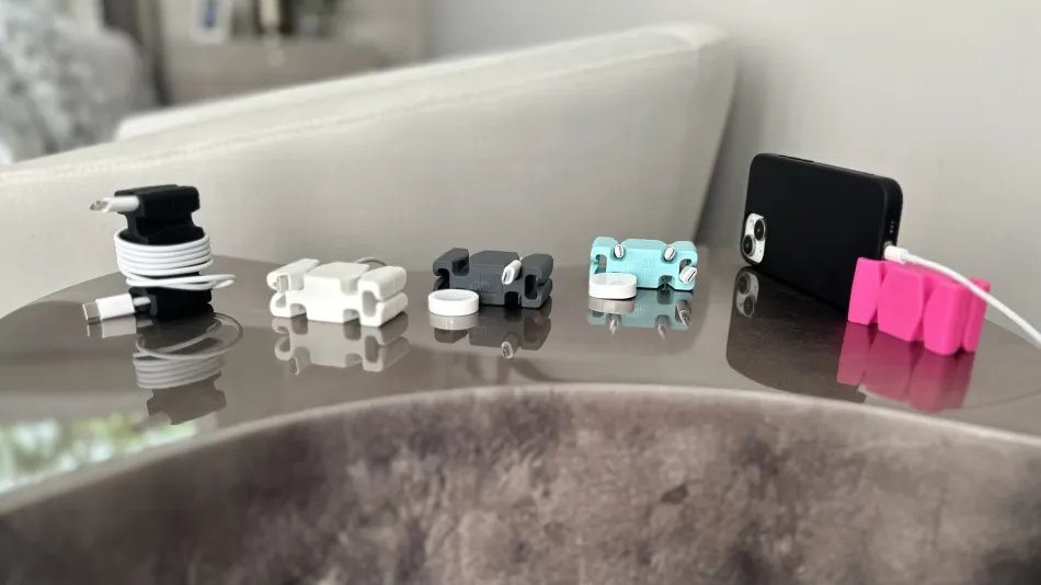 CordBrick organizers in multiple colors with cables and a phone