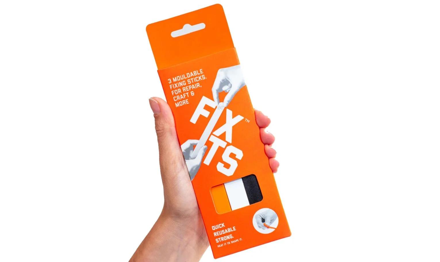 FixIts product packaging with sticks and shaped pieces displayed next to it