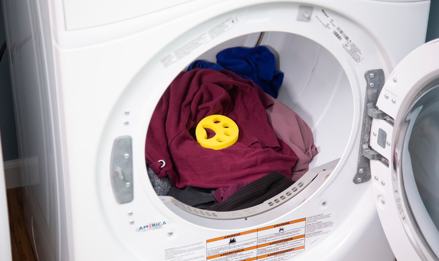 FurZapper disc placed on clothes inside a washing machine