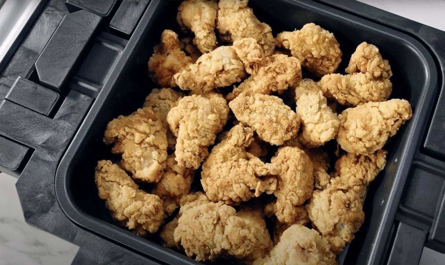 Fried chicken in air fryer basket inside Gourmax Pro