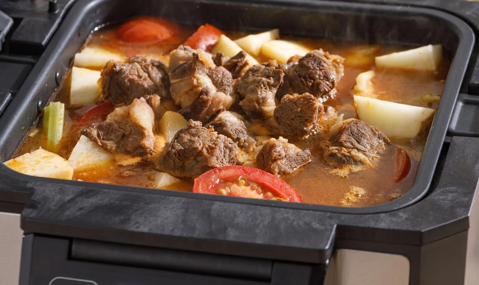 Stew with meat and vegetables cooking inside Gourmax Pro