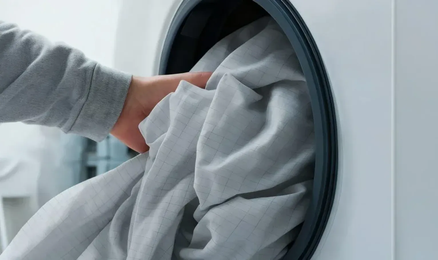 Placing the grounding sheet into a washing machine