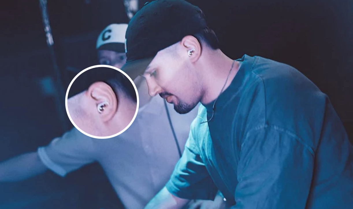 Man wearing earplugs while performing music