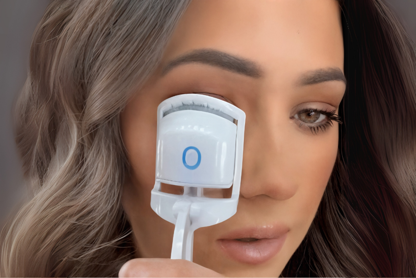 Woman applying the Bime Beauty Heated Eyelash Curler