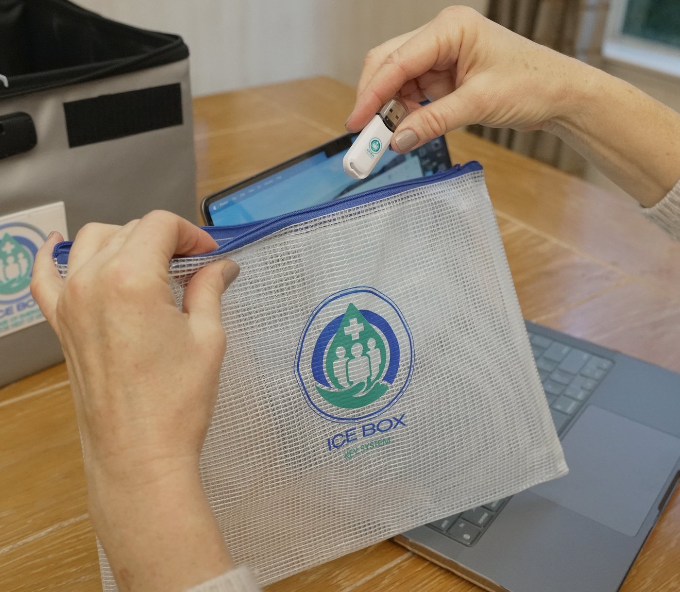 Hands placing USB drive into ICE Box pouch