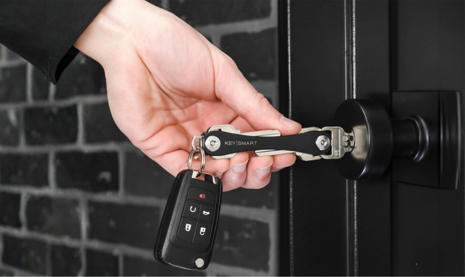 Unlocking a door with KeySmart and car key attached