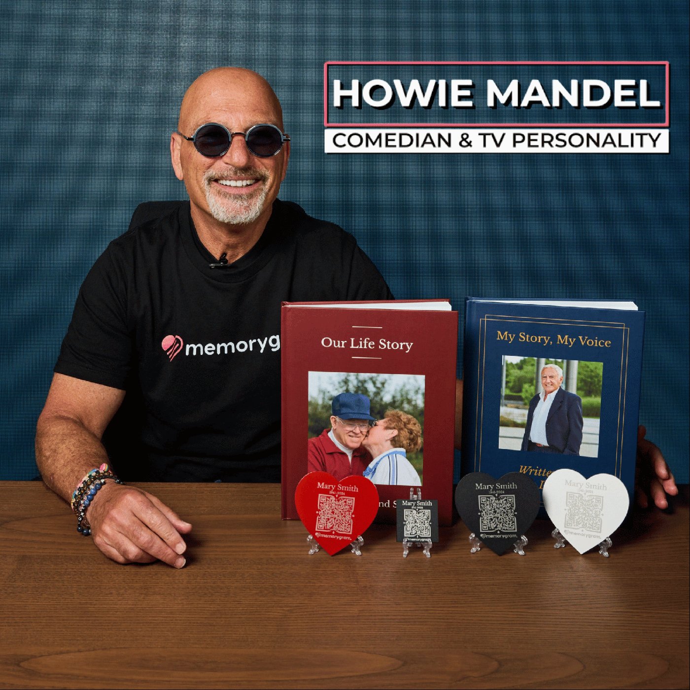 Howie Mandel holding two Memorygram Legacy Books alongside Memorygram medallions