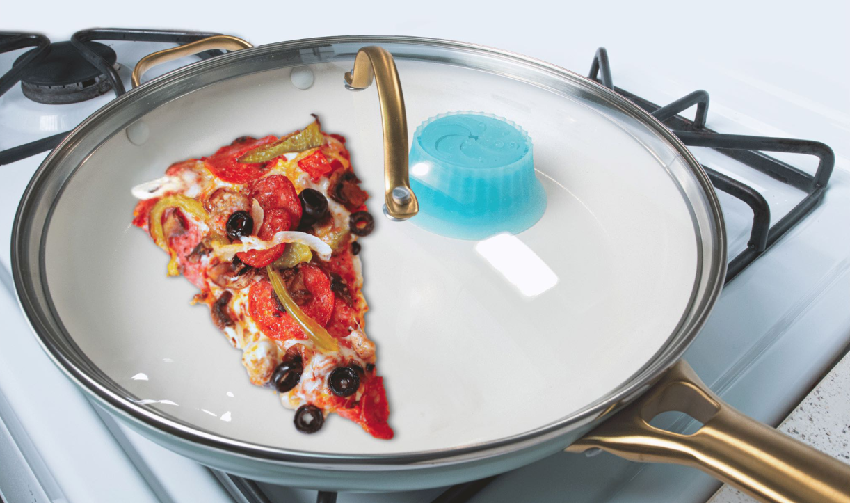 Pizza slice being reheated in a pan with Pacuzzi attached to the lid