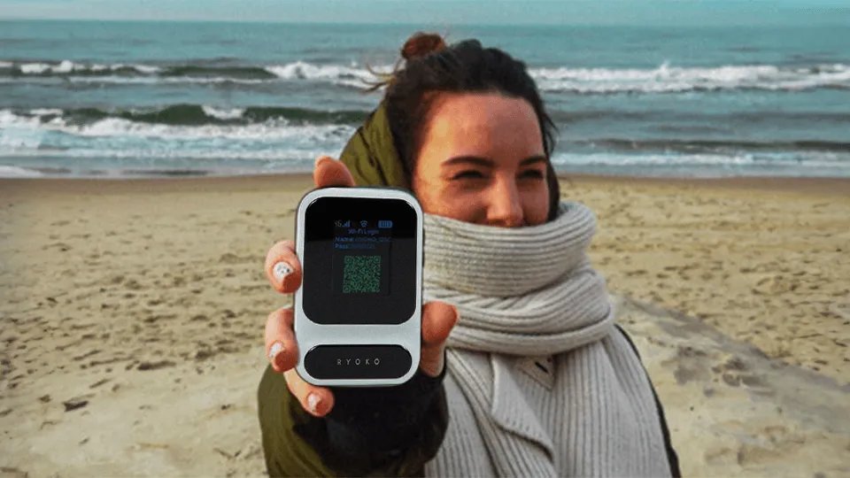 Person on a beach holding the Ryoko device up to the camera