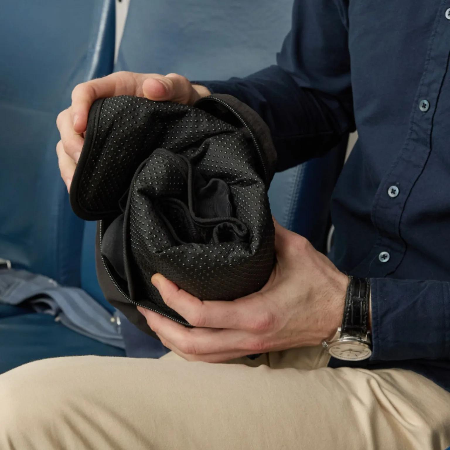 Person folding the Sondur cushion for packing