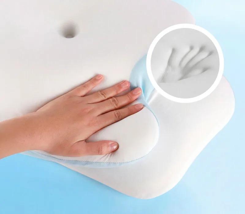 Hand pressing into VelaSleep pillow to show memory foam detail