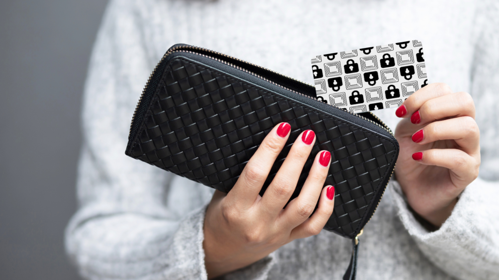 A person holding a wallet and inserting the Wallet Defender card