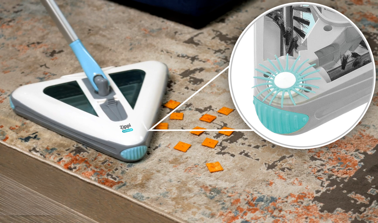 The sweeper picking up small debris with a close-up inset showing the brush detail