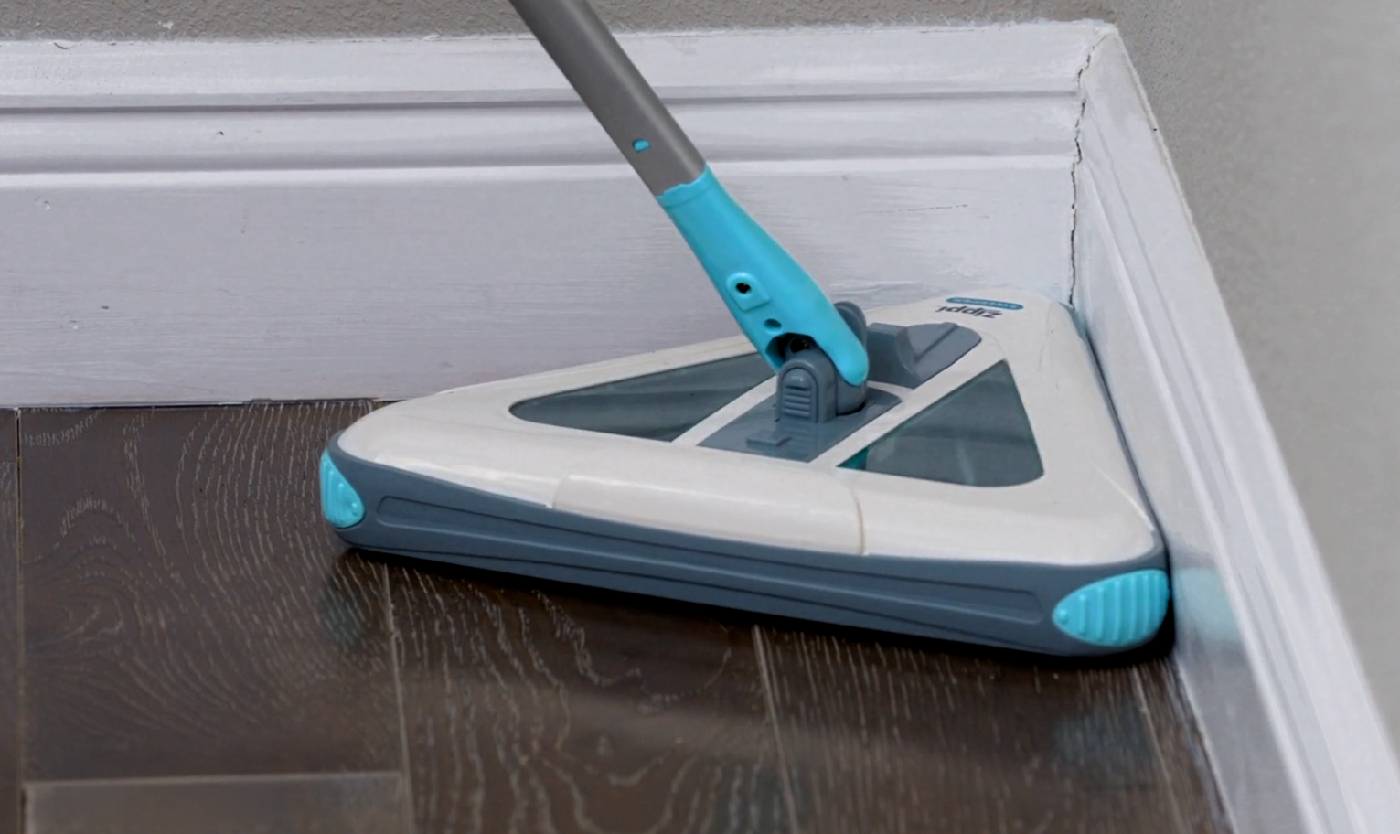 Zippi Sweeper cleaning in a tight corner on a hardwood floor