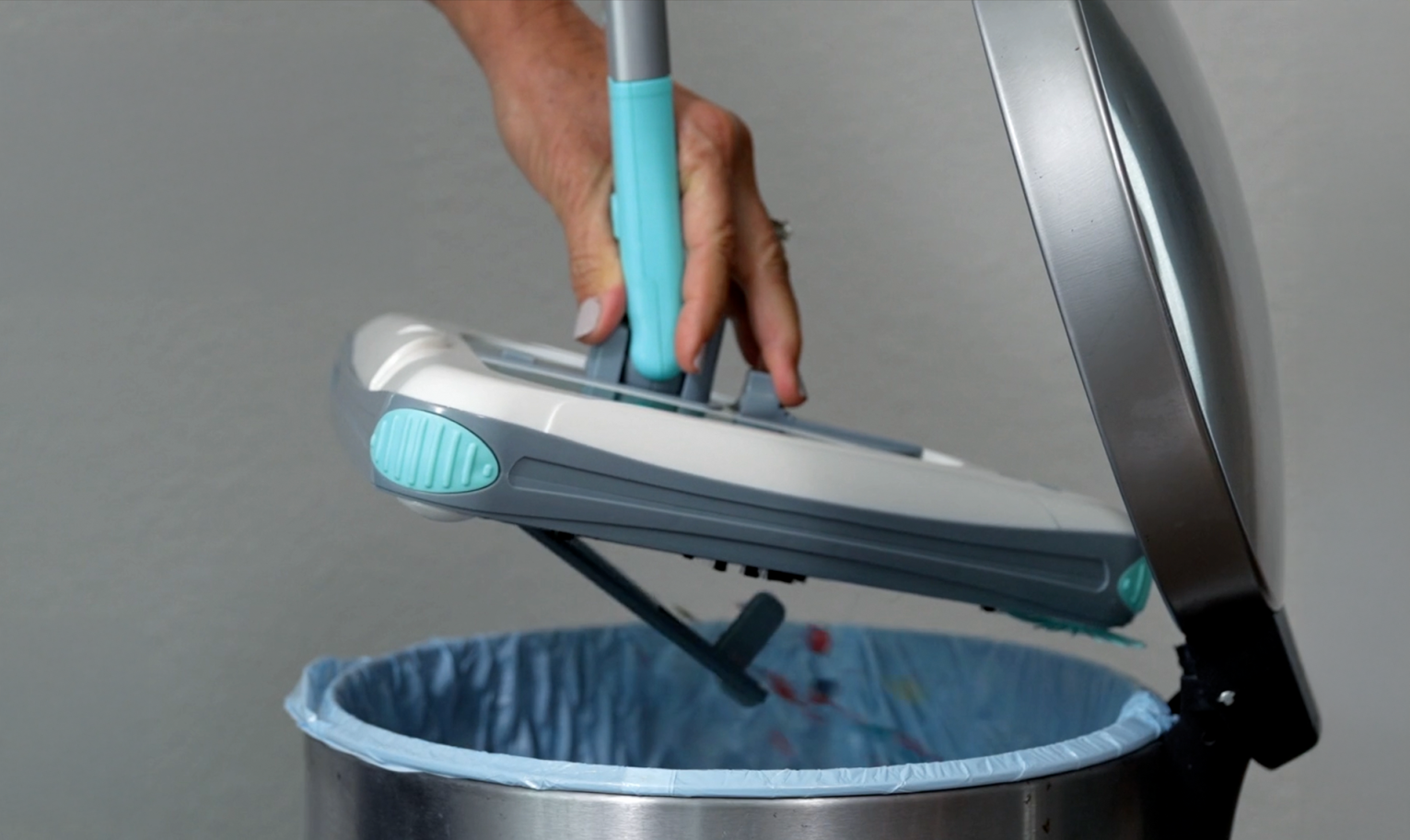 Person emptying the sweeper into a trash can
