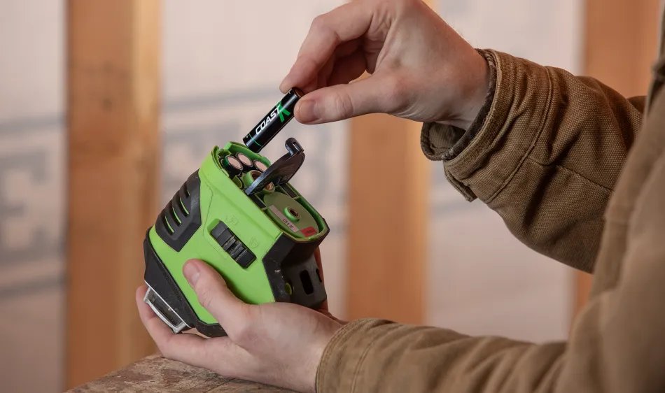 Person inserting a rechargeable battery into a smoke detector with an inset of USB-C charging